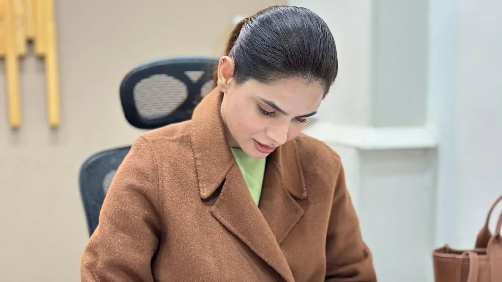 Ayesha Nasir writing a diet plan at her desk