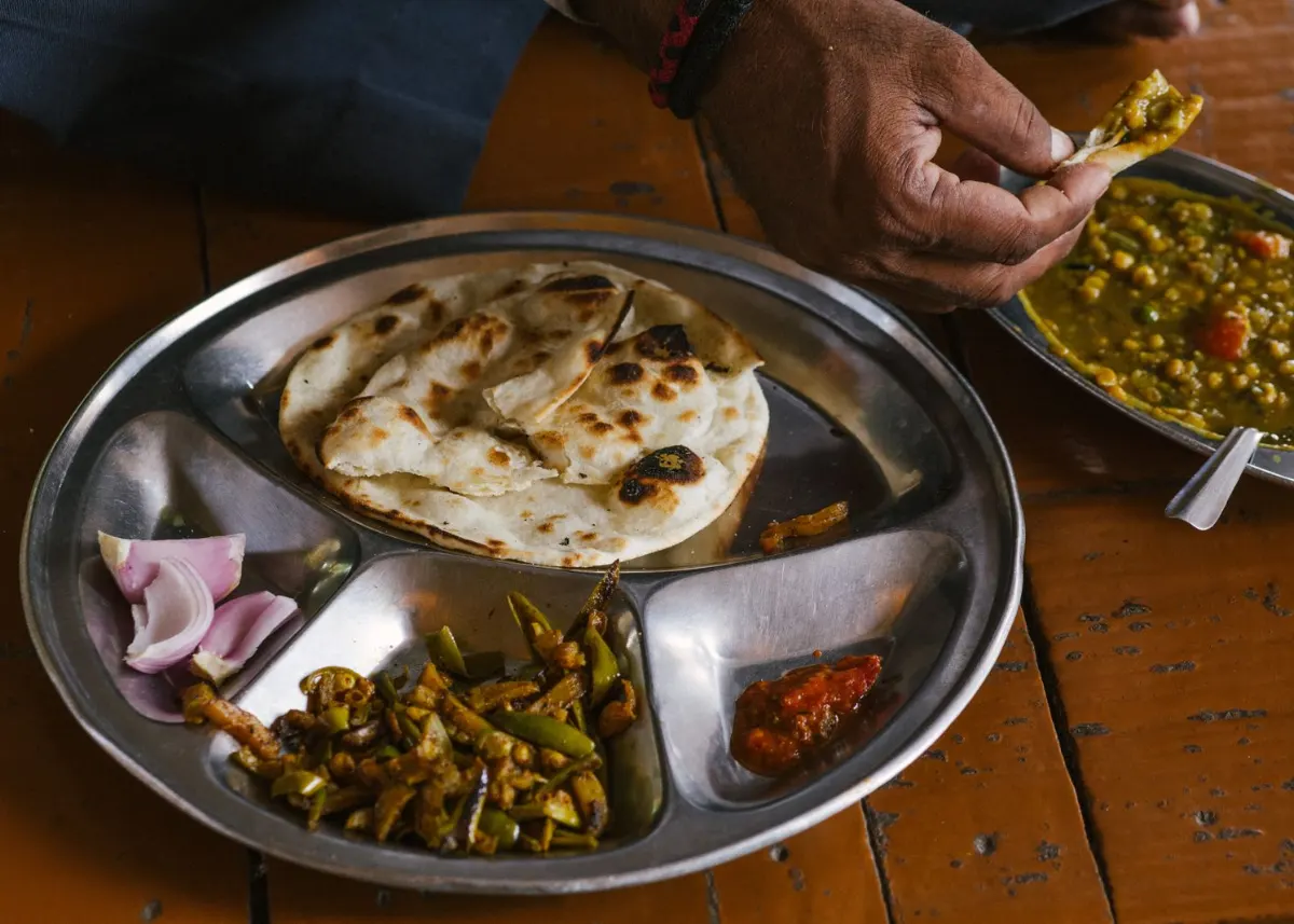 A steel tray with roti, dal and sabzi