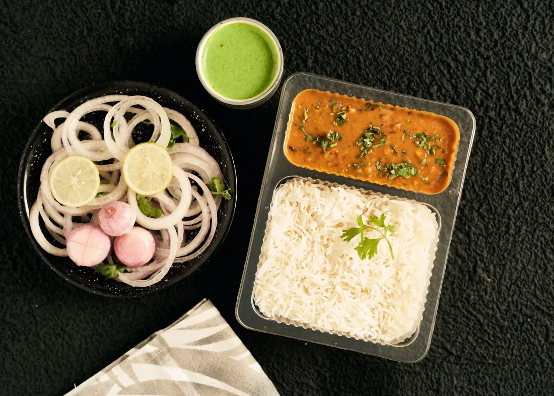 A takeaway lunch of daal, rice and onion salad from a local dhaba