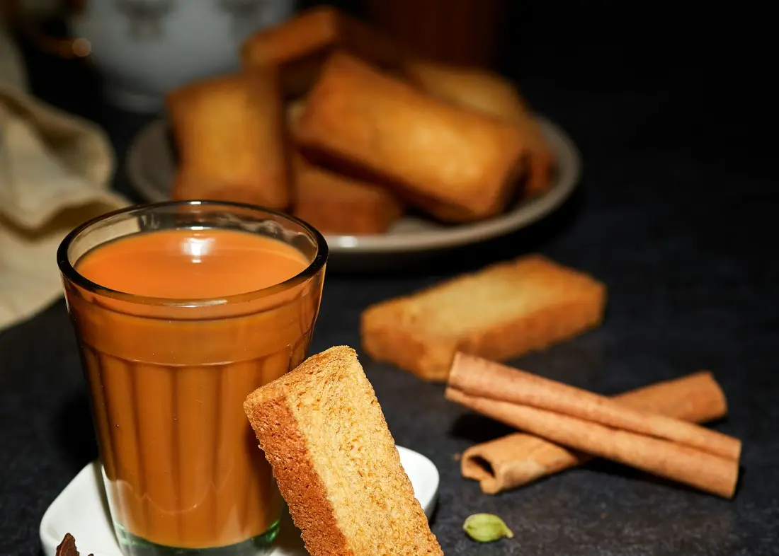 A glass of chai with rusks, the usual office tea break
