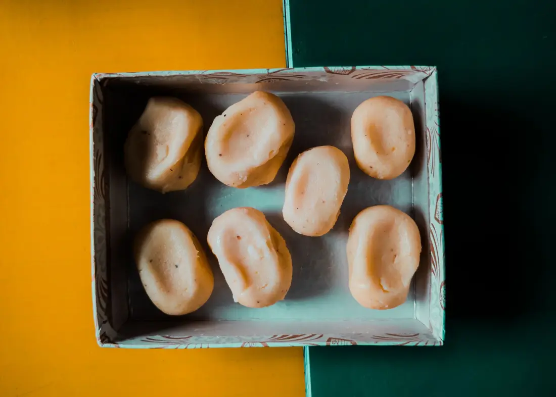 A box of milk sweets of the kind guests bring to the house