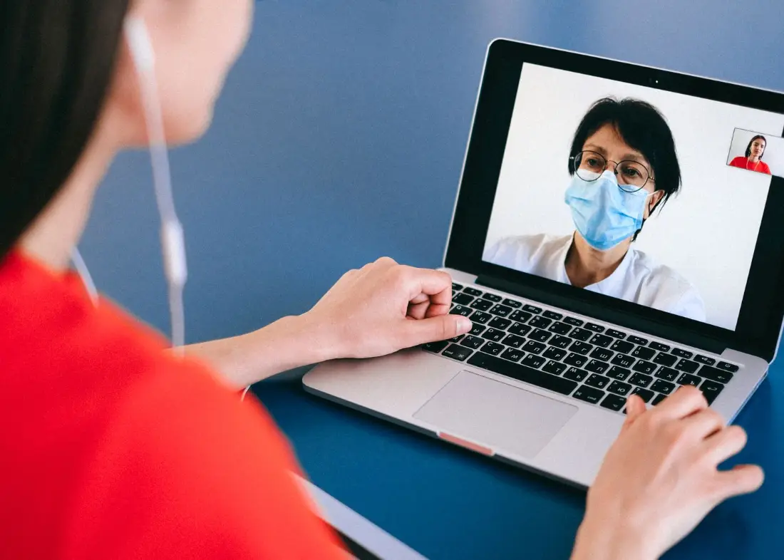 A client at home on a video consultation with a dietitian on her laptop