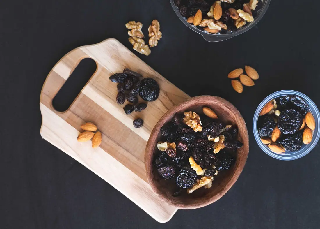 Walnuts, almonds and dried fruit in bowls