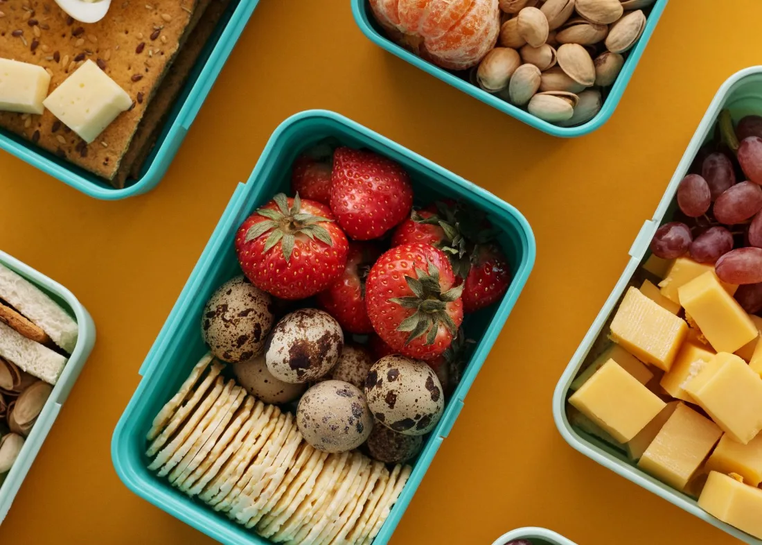 School lunch boxes packed with boiled eggs, fruit, cheese and crackers instead of canteen snacks